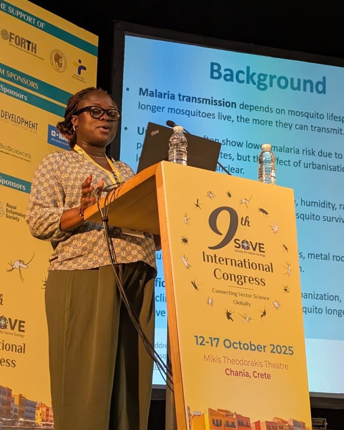 Rosine Z. Wolie at the congress lectern, in front of her background slide